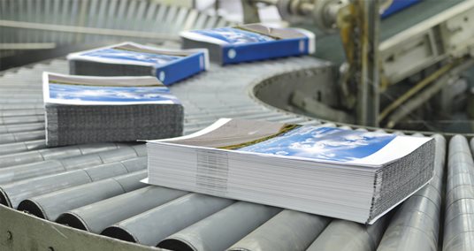 Perfect-bound books stacked on a worktable